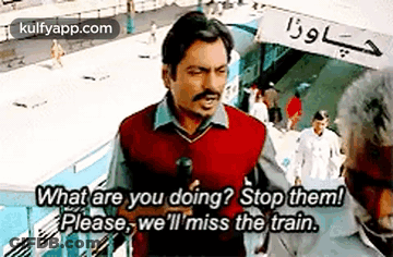 Man Talking To Another Man On Train Platform Holding Microphone GIF