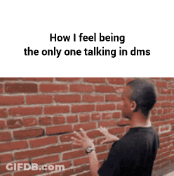 Man Talking To Someone In Front Of Brick Wall GIF