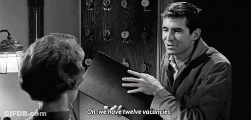 Man Talking To Woman Holding Book GIF