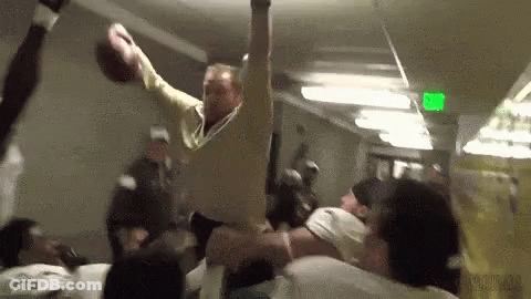 Man Throwing Football While Crowd Watches GIF