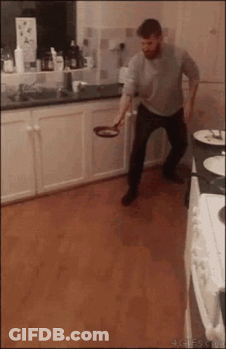 Man Throwing Frying Pan In Kitchen GIF