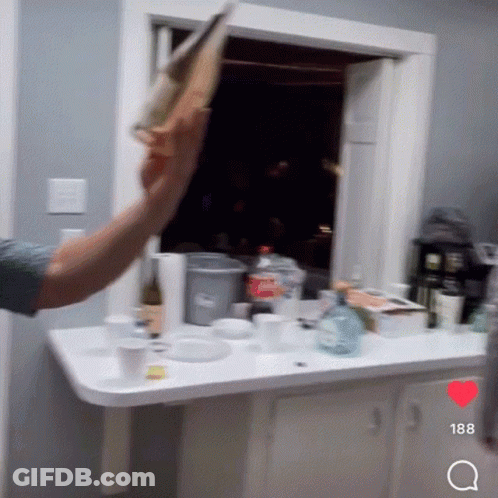Man Throwing Paper In Kitchen With Number 188 GIF