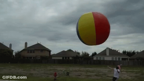 Man Throws Frisbee At Beach Ball GIF