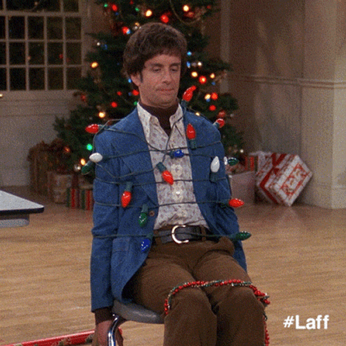 Man Tied Up With Christmas Lights GIF