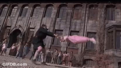 Man Tossing Girl In Front Of Building GIF