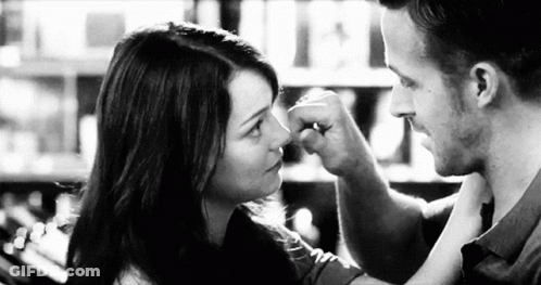 Man Touching Woman Nose With Fist GIF