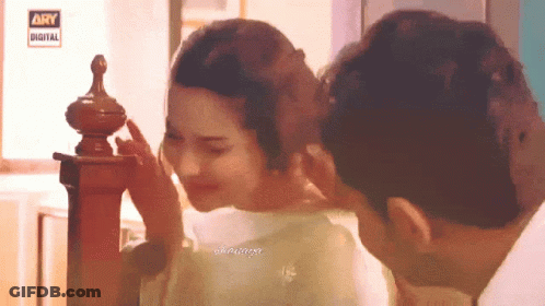 Man Touching Woman's Face In Front Of Ary Digital Sign GIF