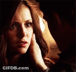Man Touching Woman's Face While Looking At Each Other GIF