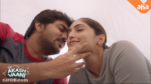 Man Touching Woman's Face With Akash Vaani Sticker GIF