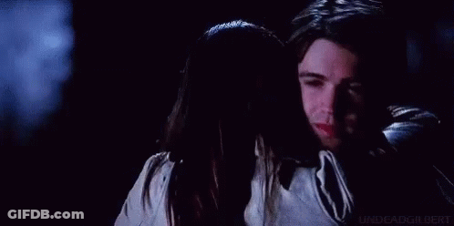Man Touching Woman's Face With Ring GIF