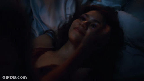 Man Touching Woman's Forehead In Dark GIF