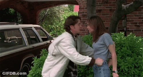 Man Touching Woman's Waist In Front Of Brown Jeep GIF