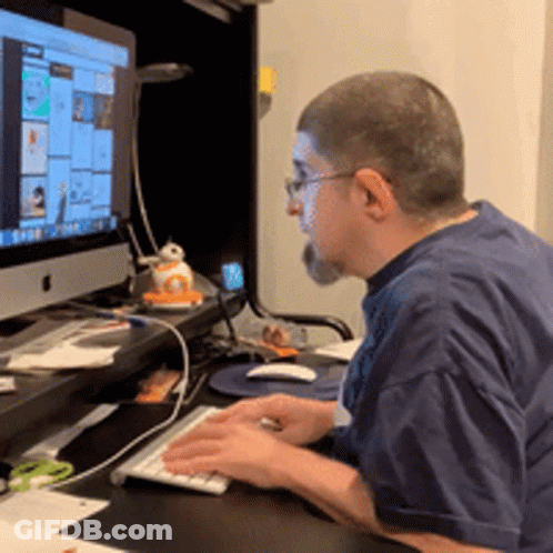 Man Typing On Keyboard In Front Of Apple Monitor GIF