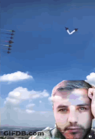 Man Under Blue Sky With Planes In Formation GIF