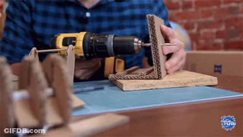 Man Using DeWalt Drill On Cardboard Box GIF