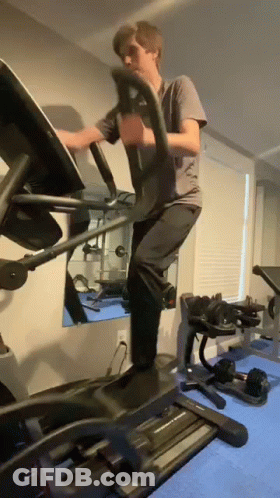 Man Using Elliptical Machine In Gym GIF