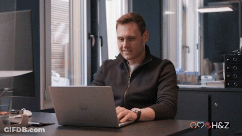 Man Using HP Laptop At Desk GIF