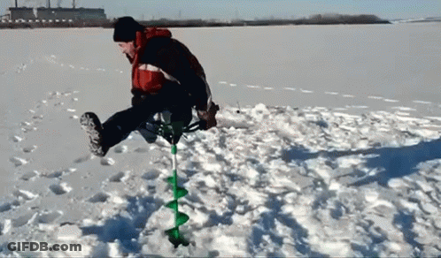 Man Using Ice Auger To Drill Hole In Snow GIF