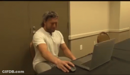 Man Using Laptop At Desk GIF