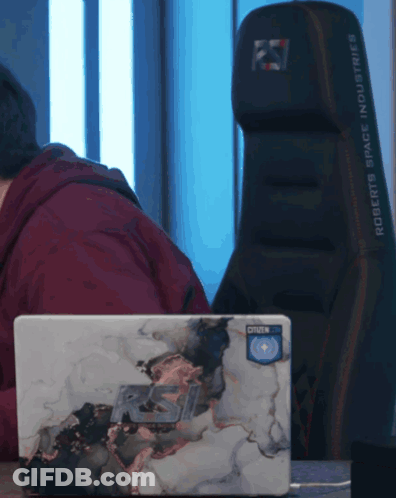 Man Using Laptop Behind Roberts Space Industries Chair GIF