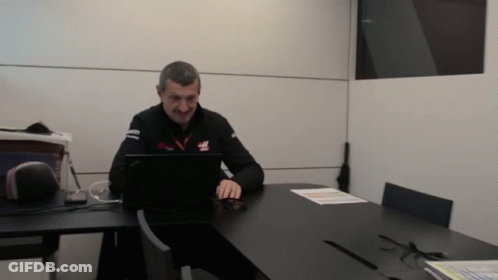 Man Using Laptop With Haas Shirt GIF