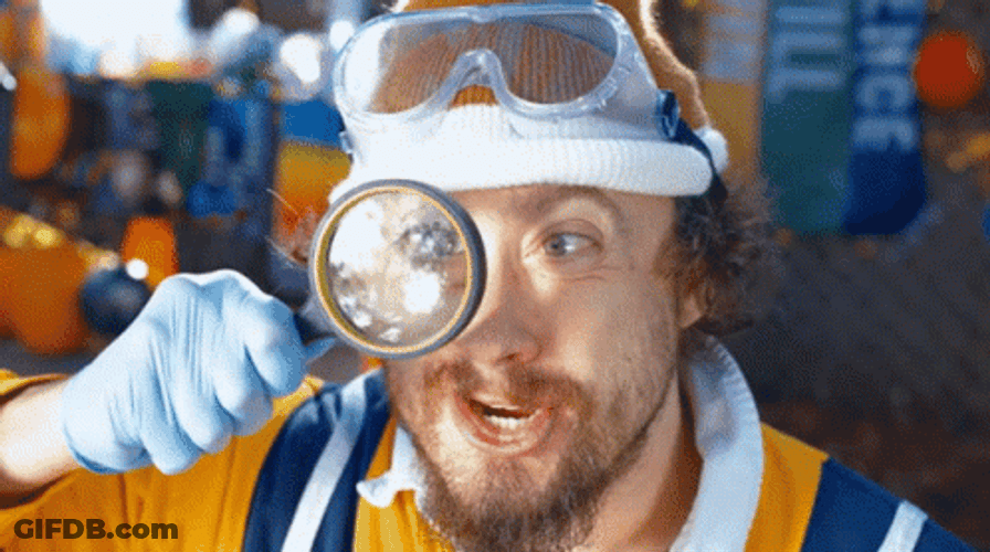 Man Using Magnifying Glass GIF
