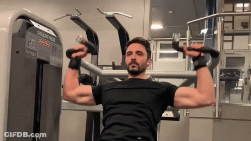 Man Using Shoulder Press Machine GIF