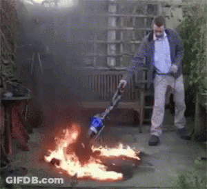 Man Using Vacuum Cleaner To Clear Fire GIF
