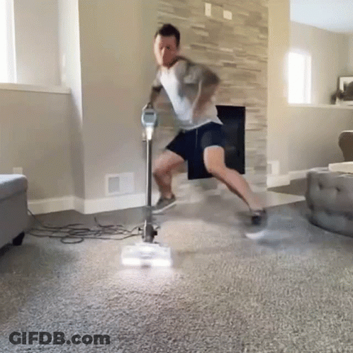Man Vacuuming Living Room GIF