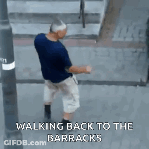 Man Walking Back To Barracks On Street GIF