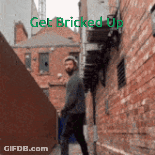 Man Walking Down Alleyway Saying Get Bricked Up GIF