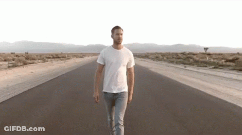 Man Walking Down Desert Road GIF