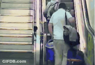 Man Walking Down Escalator With Blue Bag GIF