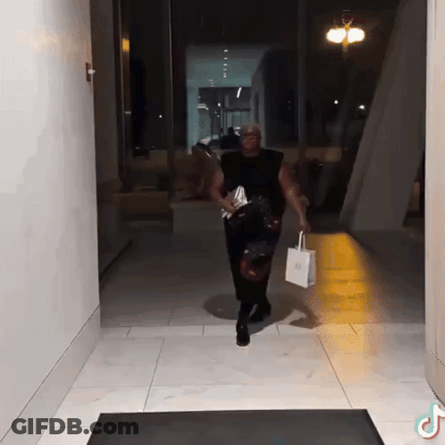 Man Walking Down Hallway Carrying Bag Saying SSS GIF