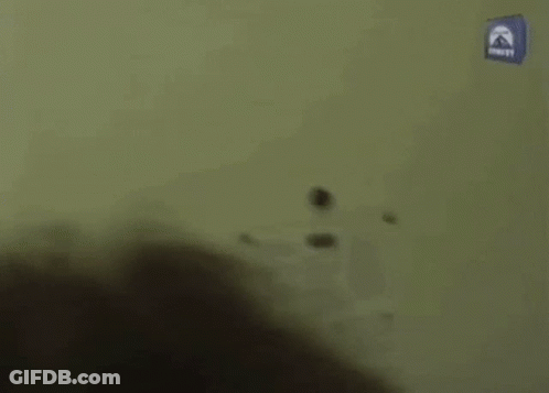 Man Walking Down Hallway Past Paramount Sign GIF