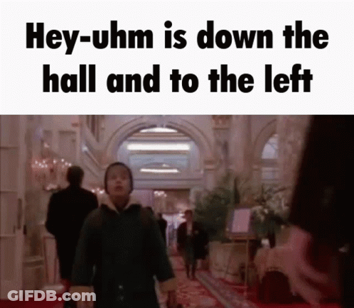 Man Walking Down Hallway Saying Hey-Uhm Is Down The Hall And To The Left GIF