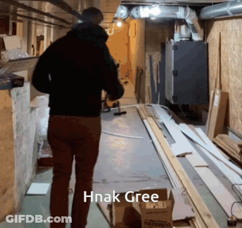 Man Walking Down Hallway With Hnak Gree GIF