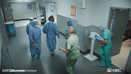 Man Walking Down Hallway With NBC Logo GIF