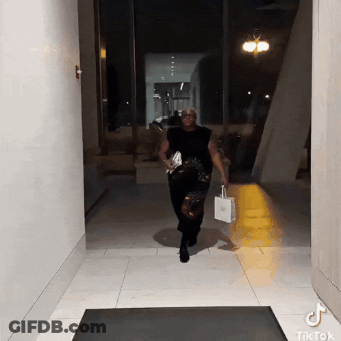 Man Walking Down Hallway With TikTok Sticker GIF