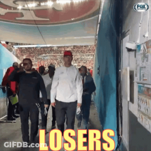 Man Walking Down Hallway With Word Losers GIF