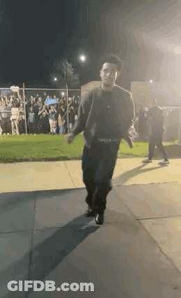 Man Walking Down Sidewalk GIF