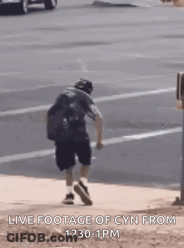 Man Walking Down Sidewalk GIF