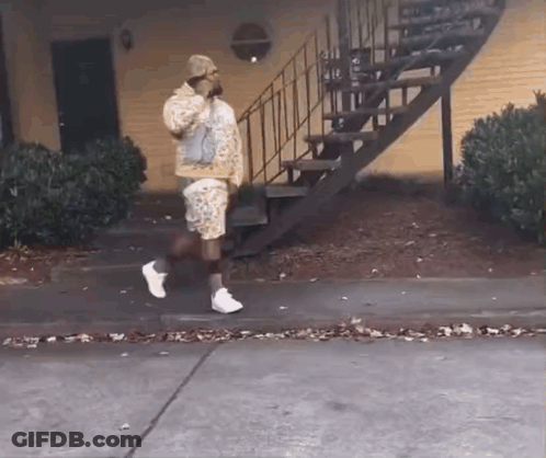 Man Walking Down Sidewalk Next To Stairs GIF