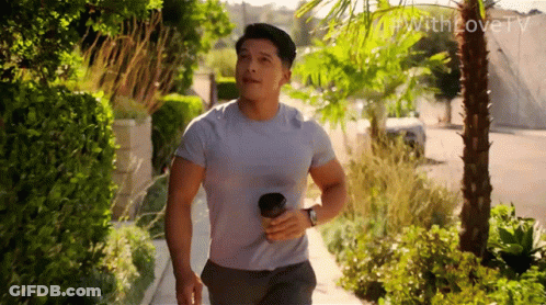 Man Walking Down Sidewalk With Coffee GIF