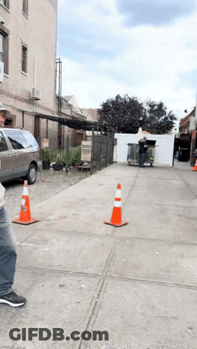 Man Walking Down Sidewalk With Van GIF