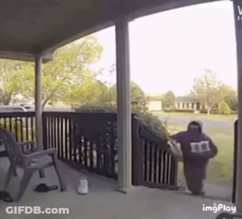 Man Walking Down Stairs Carrying Bag With Letter M GIF