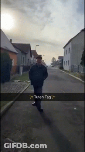 Man Walking Down Street Saying Tuten Tag GIF
