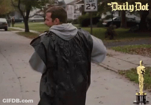 Man Walking Down Street With Sign Saying 25 GIF