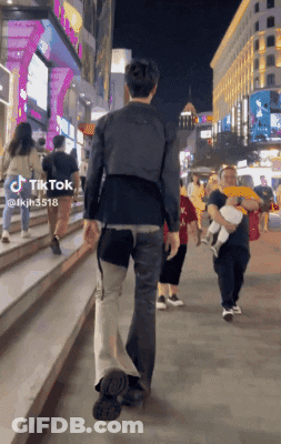 Man Walking Down Street With TikTok Sticker GIF