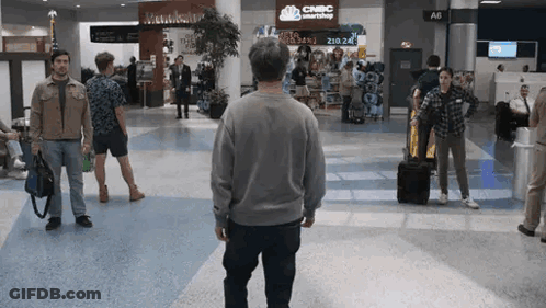 Man Walking In Airport With CNBC Smartshop On Wall GIF